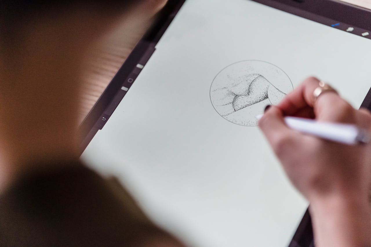 services-04 From above of crop anonymous artist with stylus in hand drawing creative sketch on graphics tablet